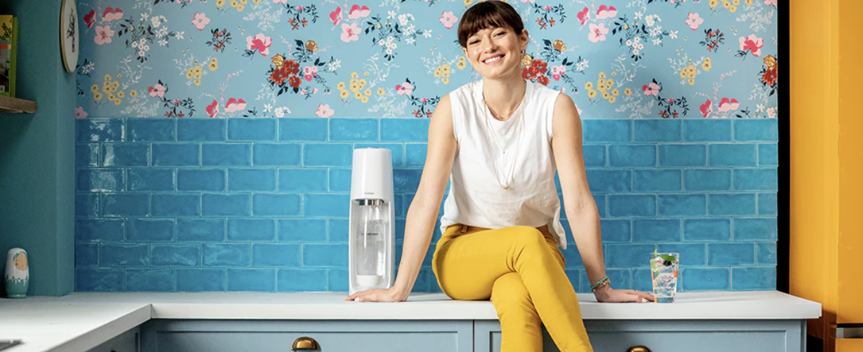 Girl sitting with Soda stream